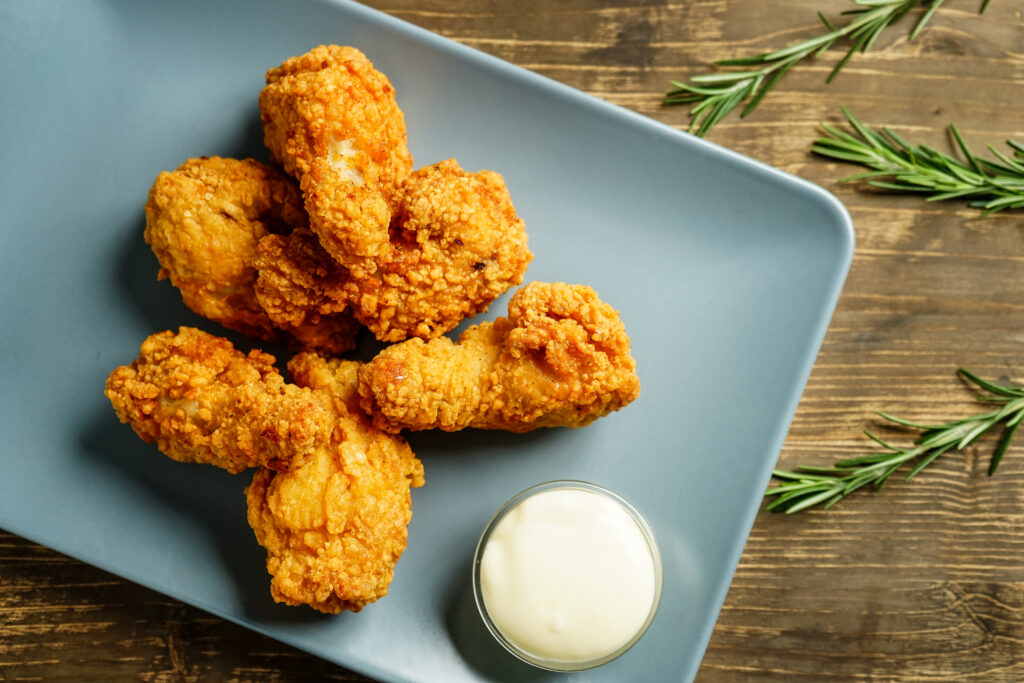 Broasted Chicken wings or Pressure Fried Chicken wings on a plate with ranch dressing